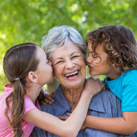 Pilgrims Hospices Make a Will Month 2018 - shows family kissing on a bench