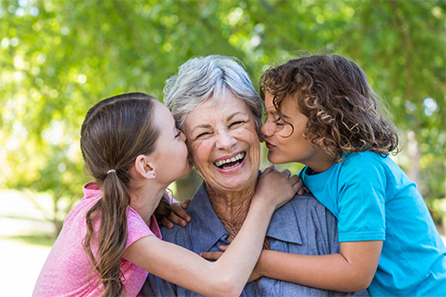 Pilgrims Hospices Make a Will Month 2018 - shows family kissing on a bench