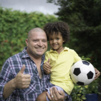 Portrait Of Father And Son, Boy Holding A Soccer Ball