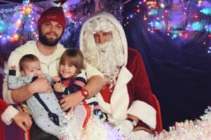 Santa (Dave Hall) with Danny Waters and his children Esmae (4) and Elliot (7 Months)